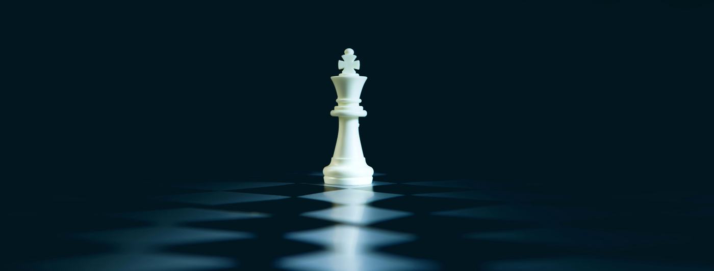A white king alone on a dark board