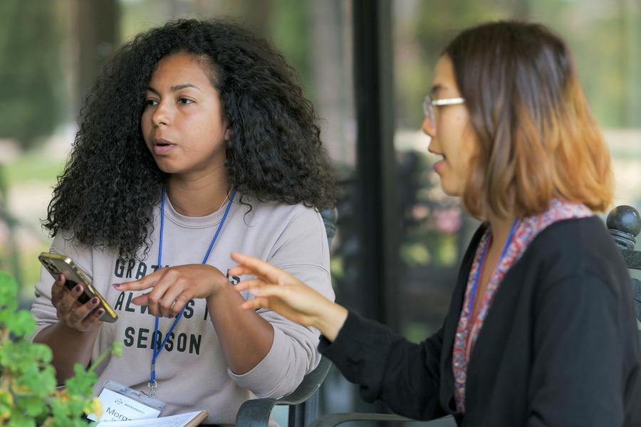 Two colleagues in discussion at a professional gathering