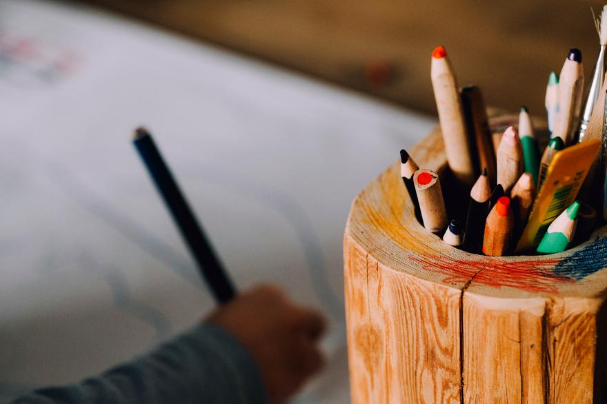 Sharpened coloured pencils in a wooden holder