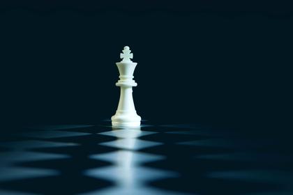 A white king alone on a dark board