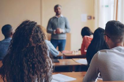 A teacher standing before a class